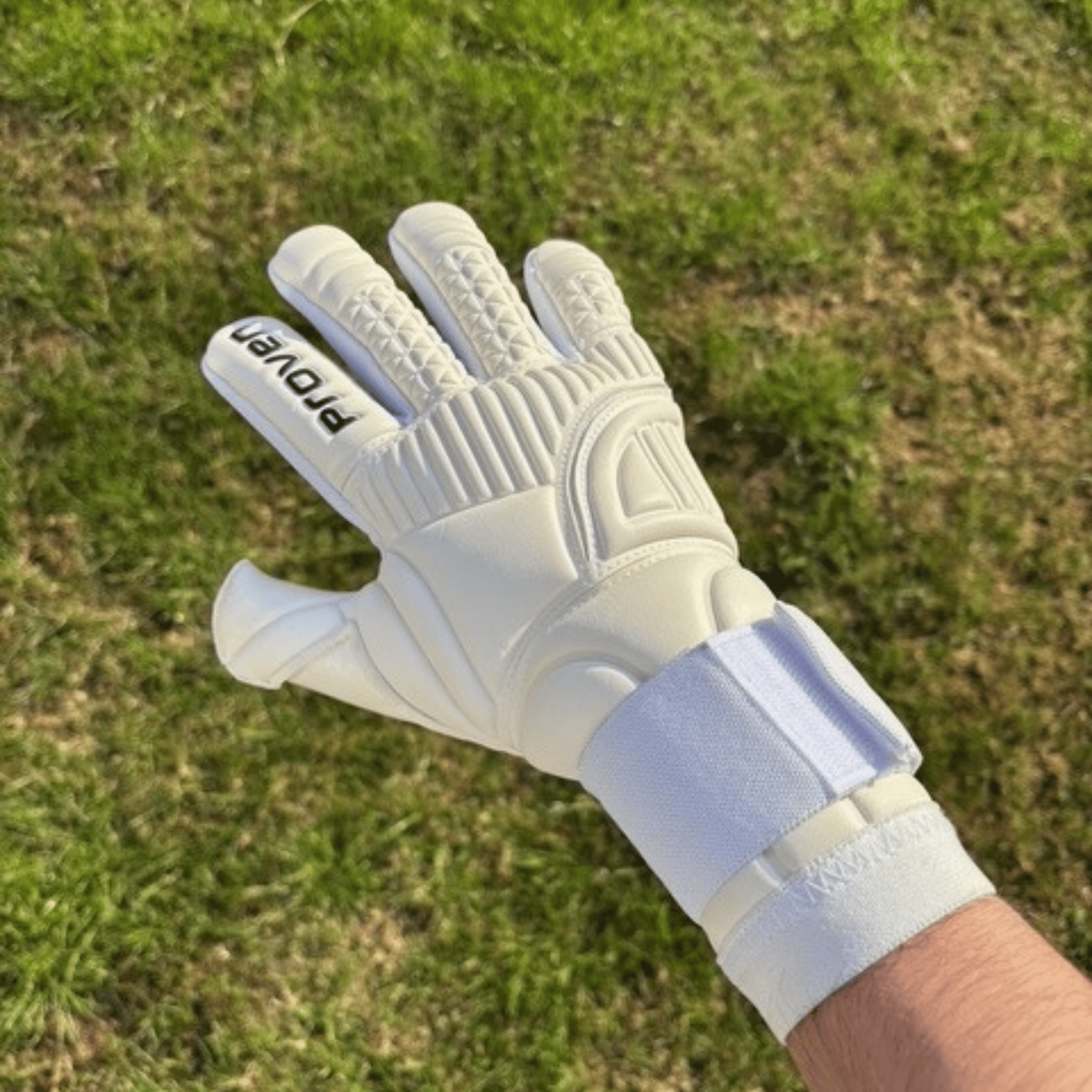 White glove with 'Proven' branding on a grass background