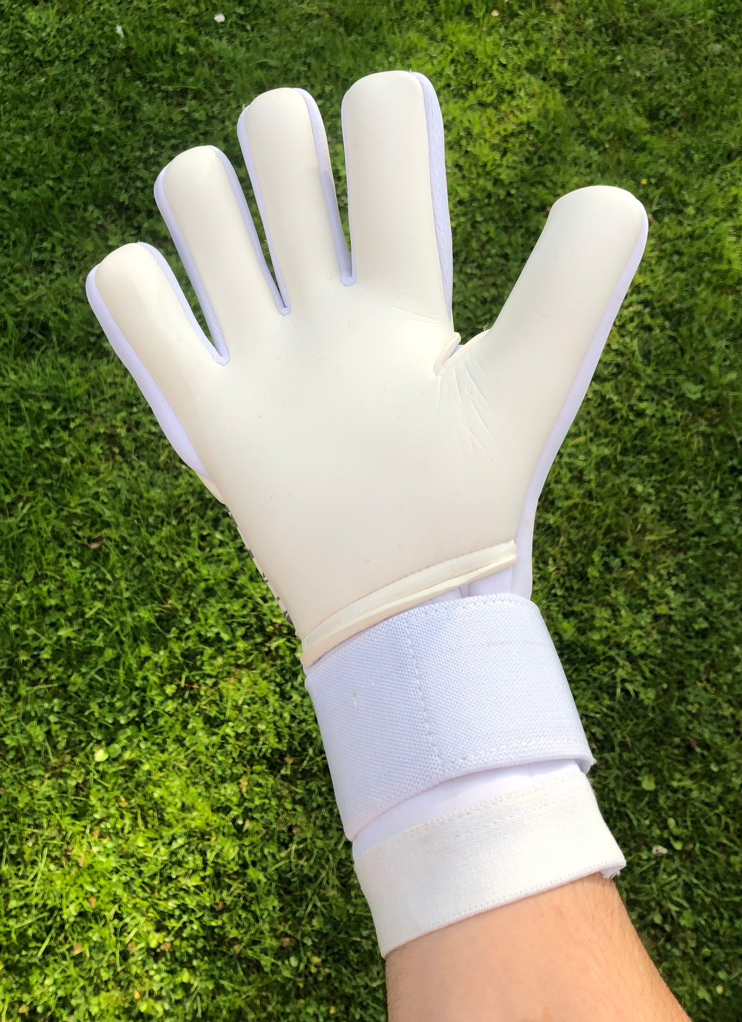 white out palm on somebodies wrist outside with background of grass
