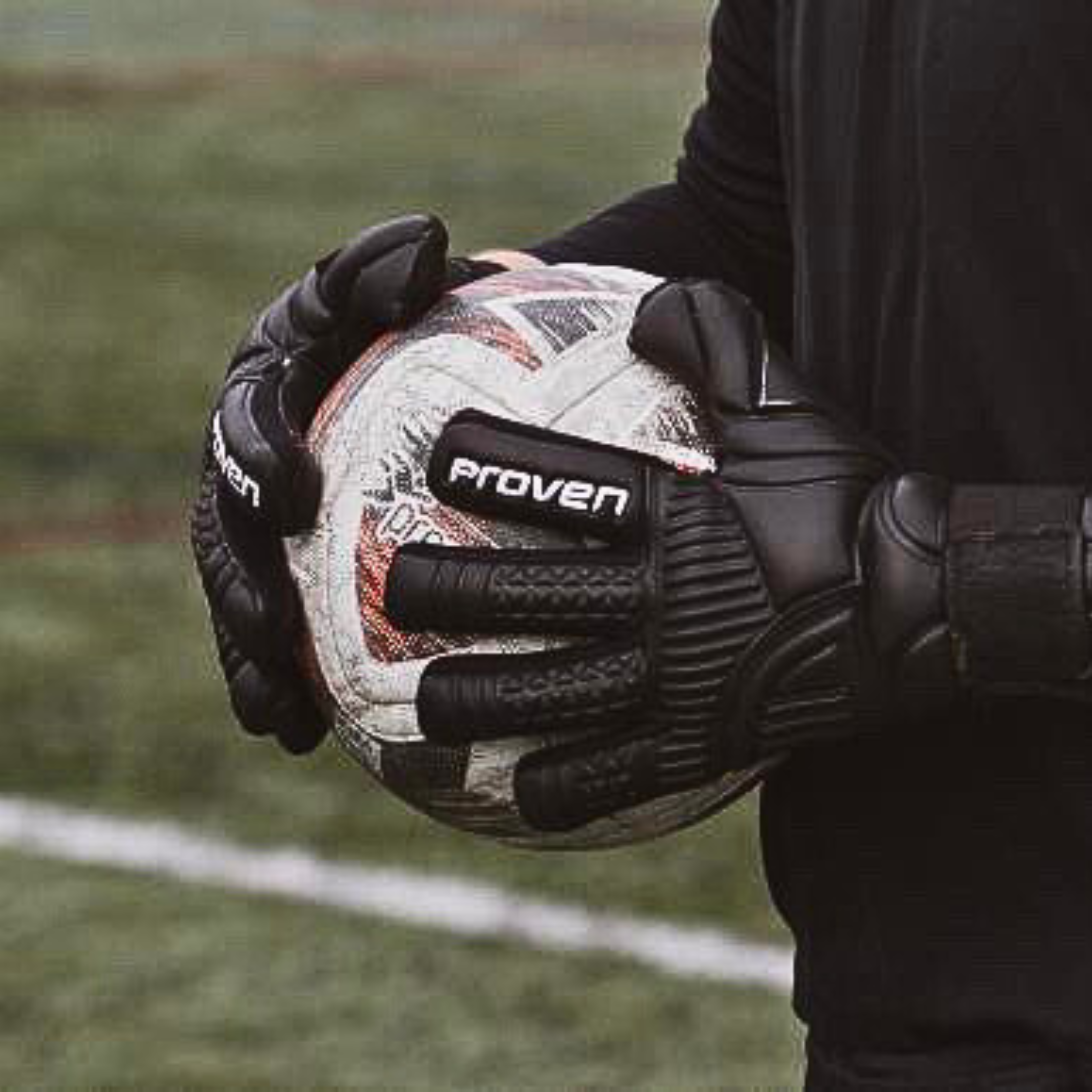 Person holding a soccer ball with 'Proven' branding on gloves and ball.