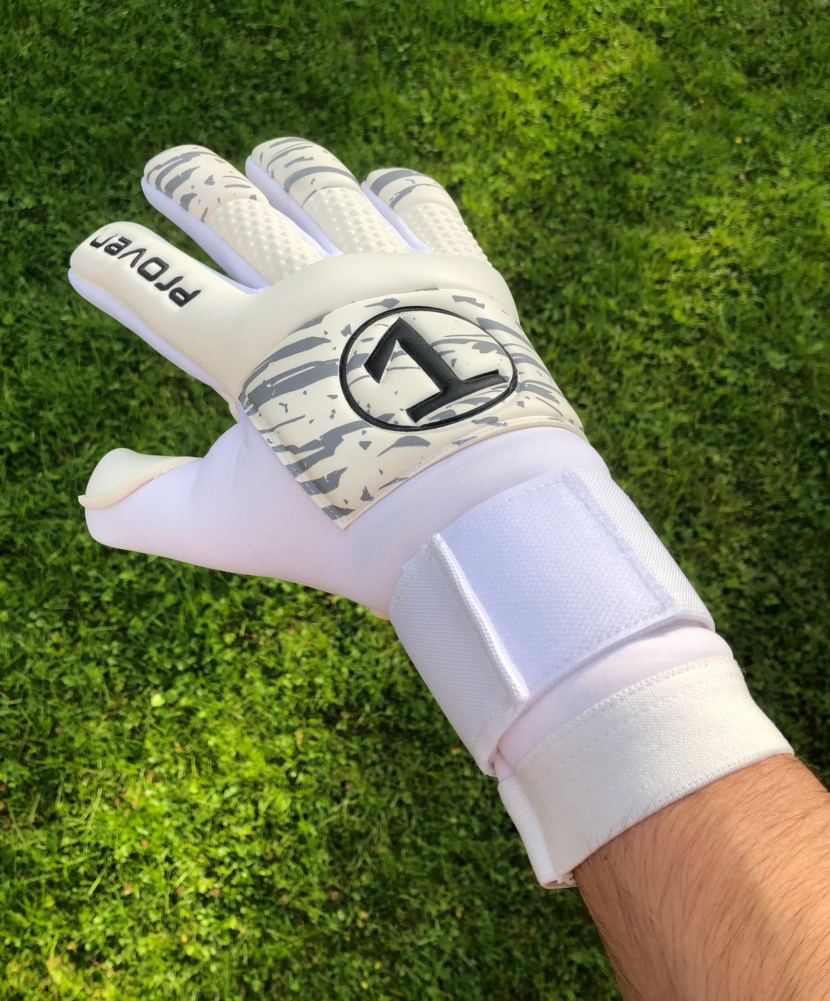 white out outside on keepers wrist with grass in the background